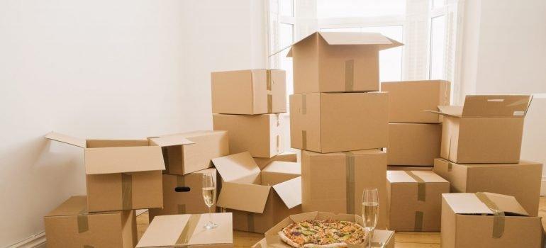 Pizza and champagne on moving boxes