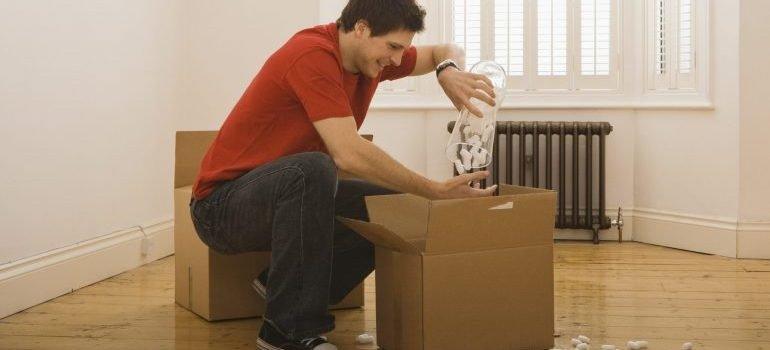 Man unpacking boxes in new home - Orlando long distance movers