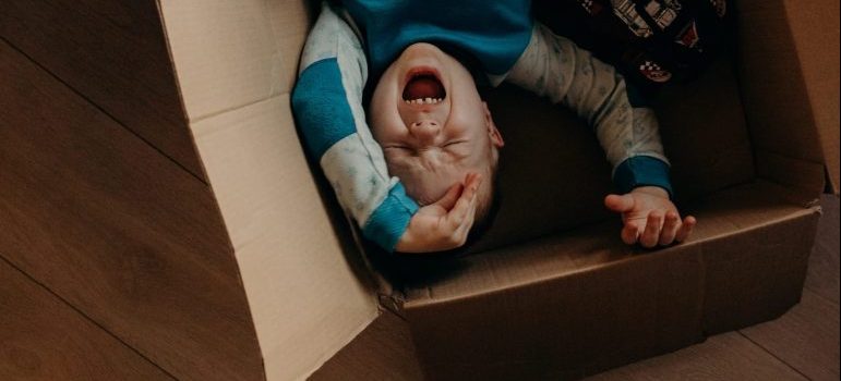 kid playing in a box