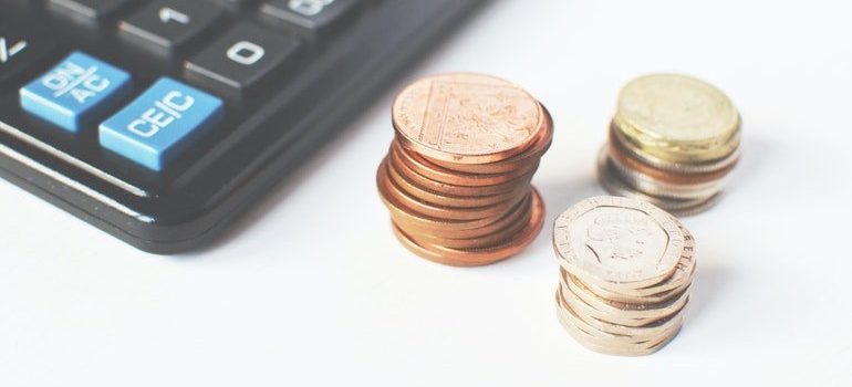 Coins next to a calculator.