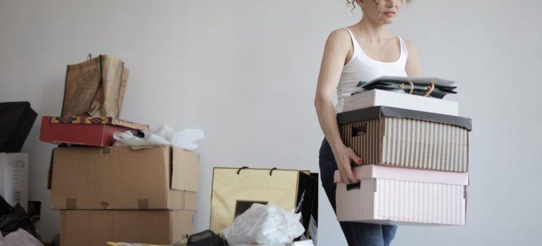 -a woman carying boxes