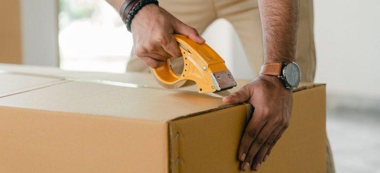 one of the cross country movers Austin has to offer taping a box