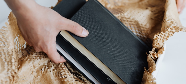 a person putting books in a box