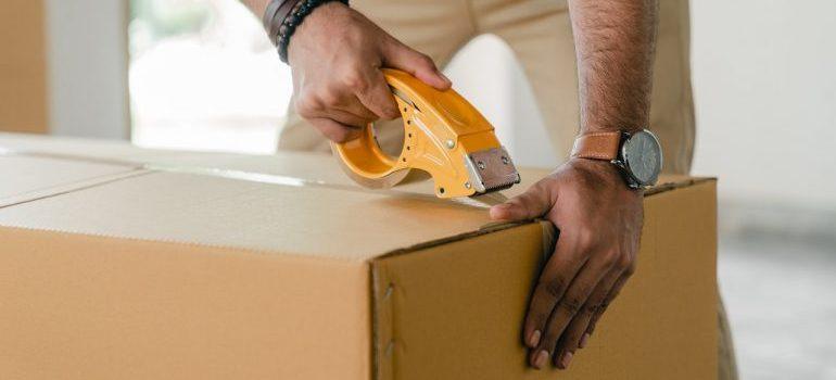 A man taping a box
