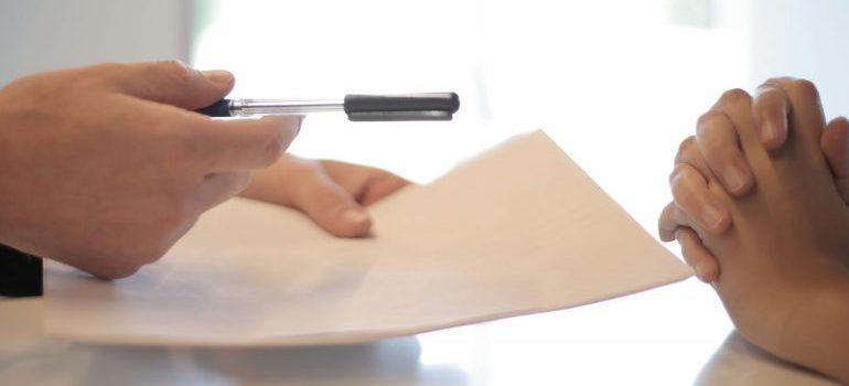 businessman-giving-contract-to-woman-to-sign