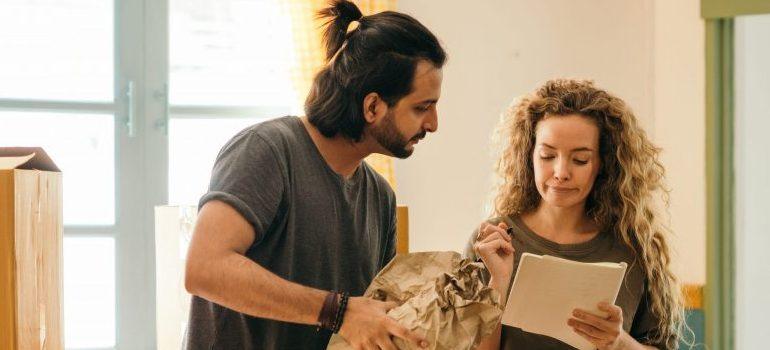 happy-couple-unpacking-boxes-in-new-home