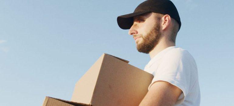 male carrying moving boxes