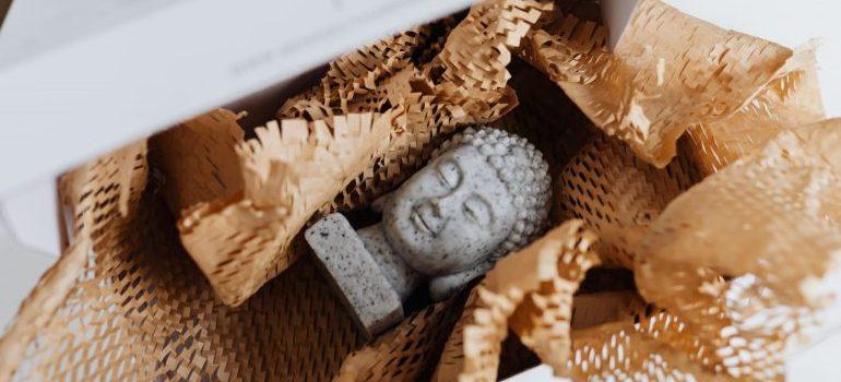 statue of Buddha in a cardboard box