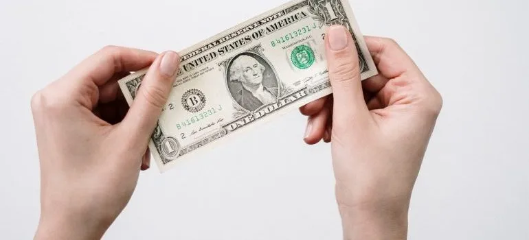 a person holding a dollar bill 