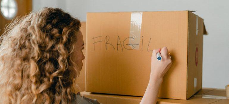 woman labeling a box