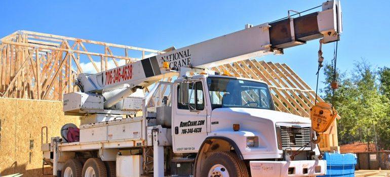 blanco camión grúa en una obra en construcción