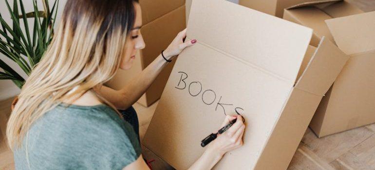 woman labeling the boxes