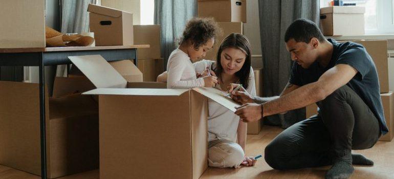 parents helping daughter to unpack after the move