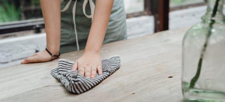 a person with a cleaning cloth