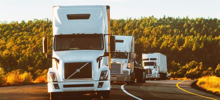 three trucks on the road