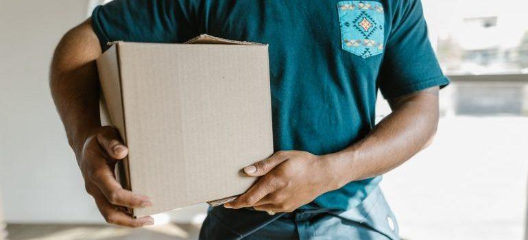 A mover holding a moving box