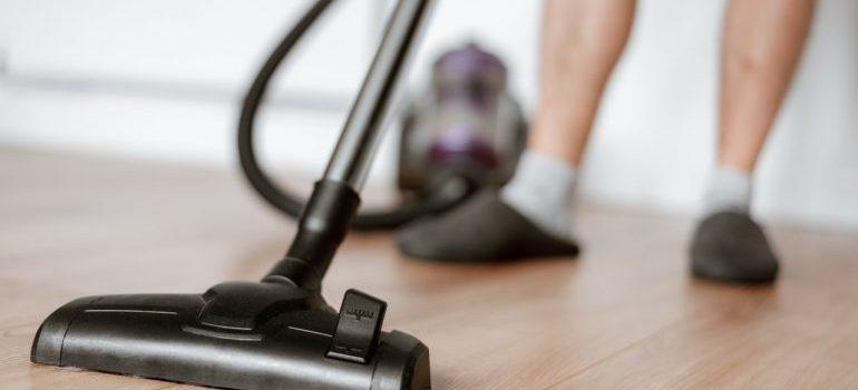 a man vacuuming the floor