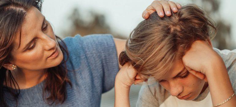 mother taljking to her son who is quite sad