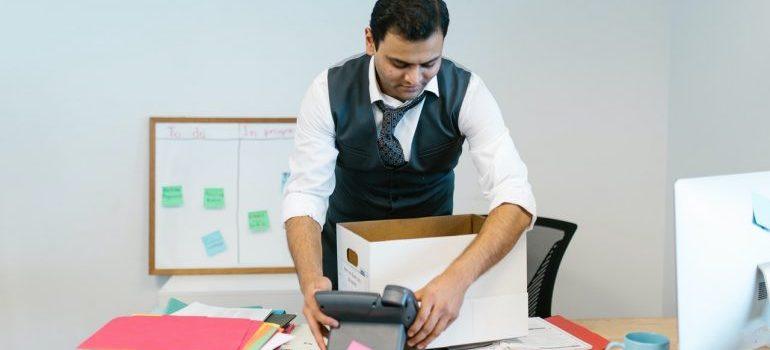 a man packing his desk when moving your office in NYC