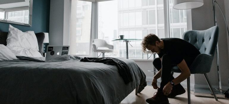 A man preparing for work in his hotel room
