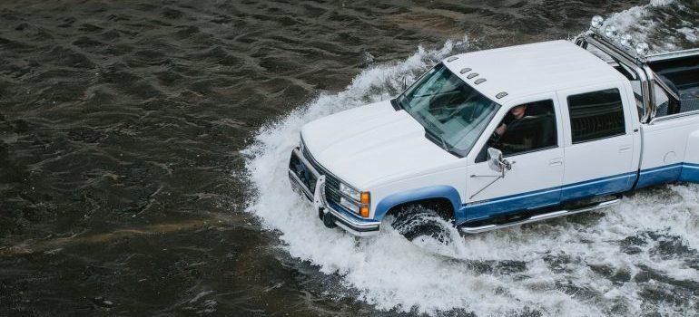 A car driviing on a flooded road