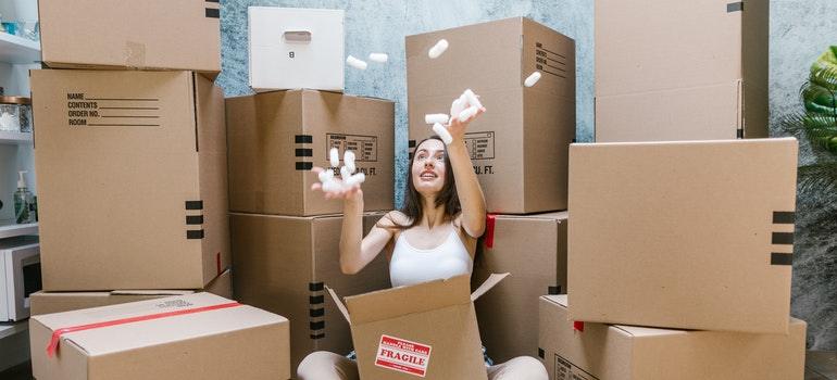 a woman playing with the moving box