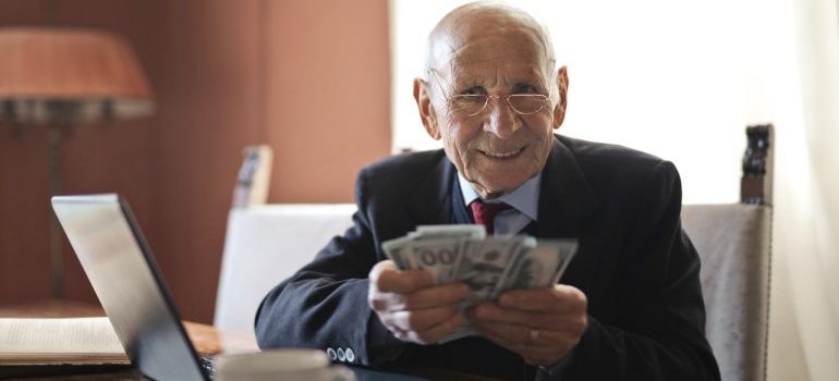 An older person showing off money