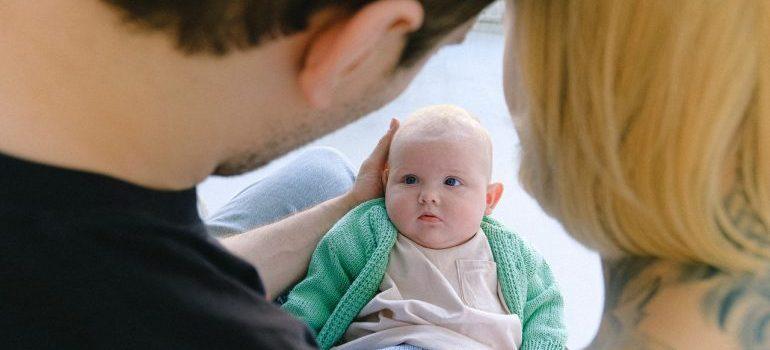 parents holding baby