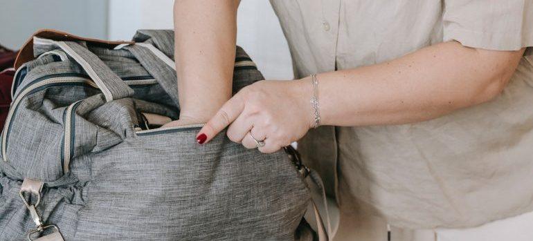 woman packing baby bag for moving to NJ or VA