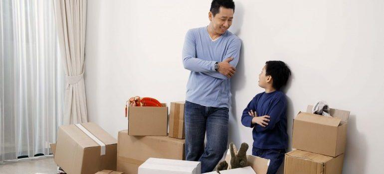 father and son unpacking boxes after a move