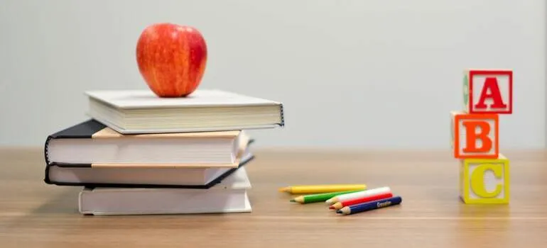 red apple on stack of books