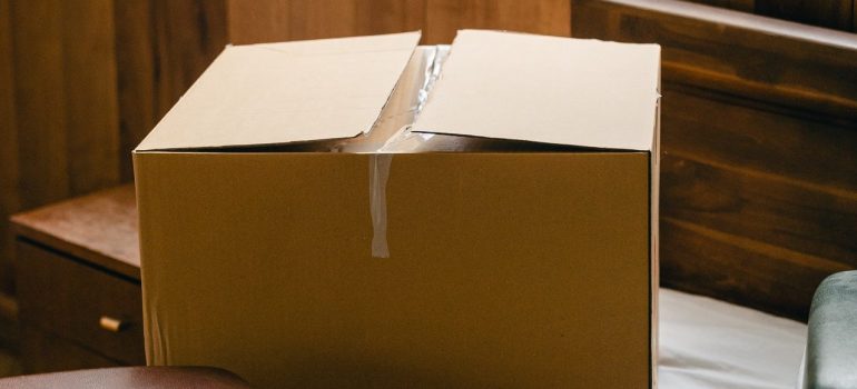 A cardboard box with open upper side. 