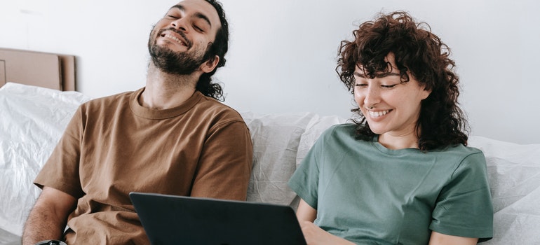 couple looking for interstate movers Houston on their laptop