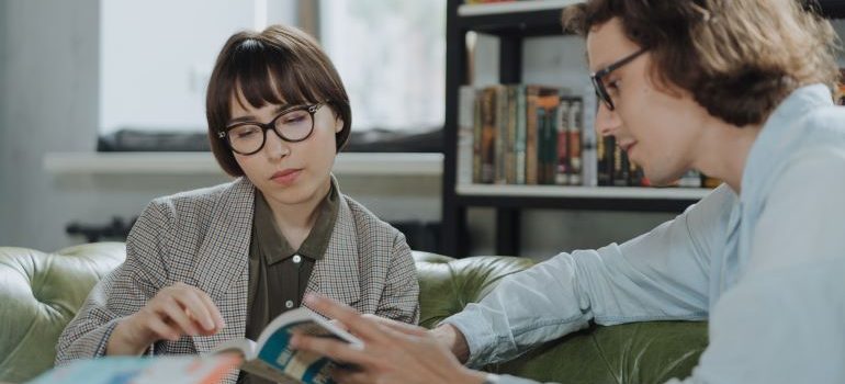 two people looking at books