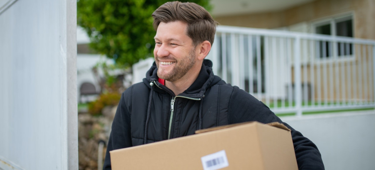 a man carrying cardboard box