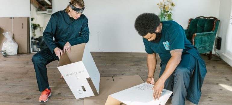 two movers preparing for packing