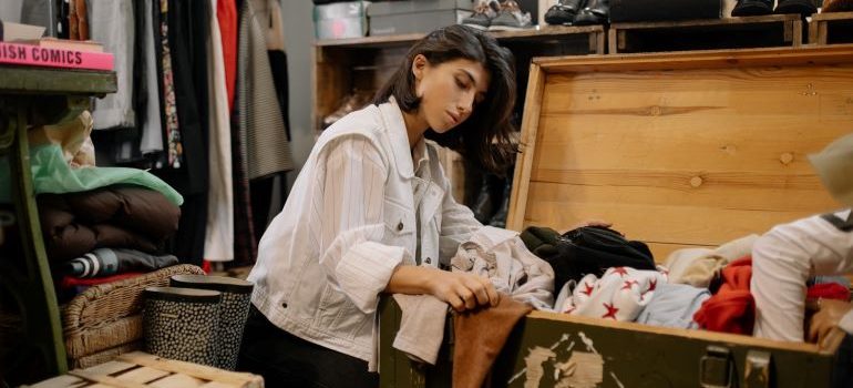 a woman shuffling through old items