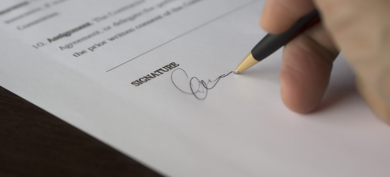 a person signing divorce papers before Moving out of state after a divorce