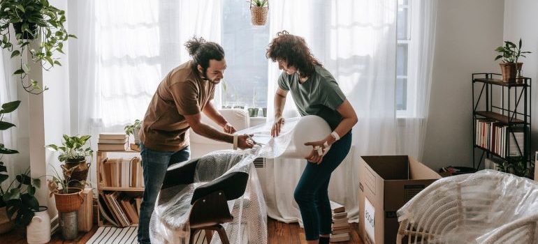 a couple wrapping a chair