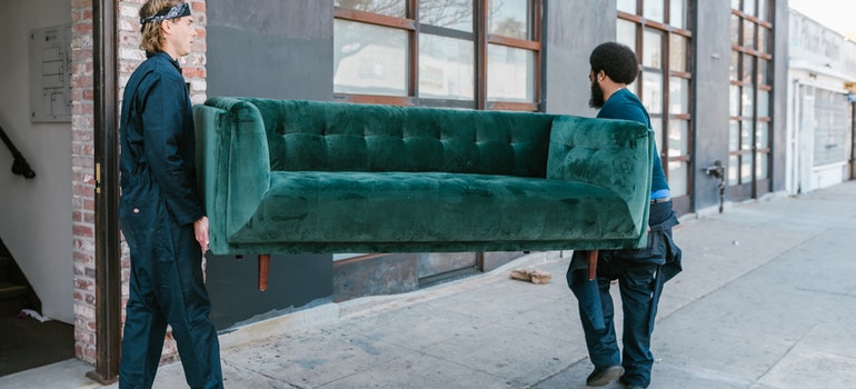 movers carrying a couch helping you get ready for moving to Annapolis 