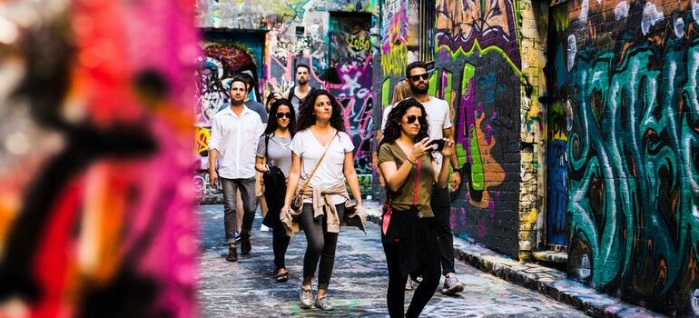 A group of people walking down the street to adapt after moving to The Woodlands