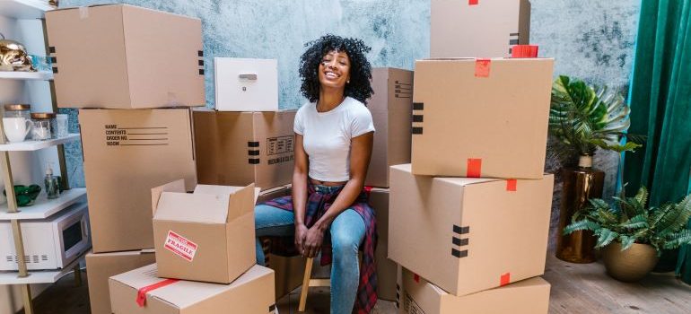 woman surrounded with boxes smiling