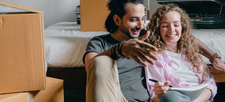 A couple reading about how to pack your bedroom for the move