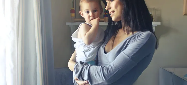 A woman carrying a baby