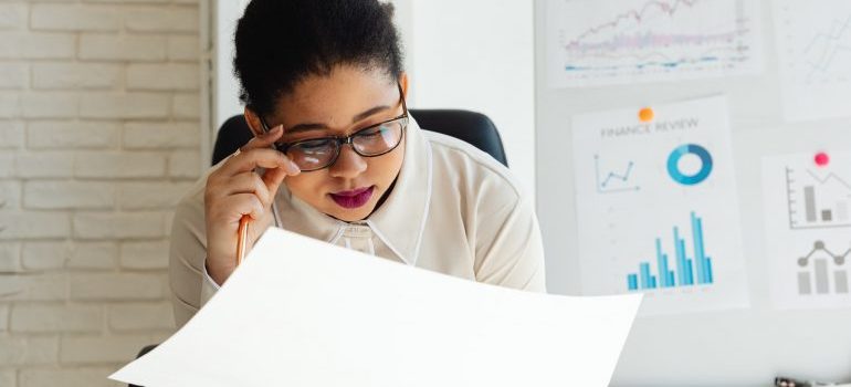 Woman with glasses looking at papers about starting your business in Florida