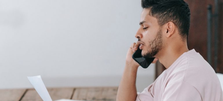 Man on the phone talking about hiring reliable Fresno movers 