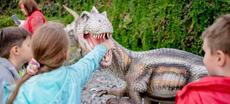 Children playing with dinosaur model 