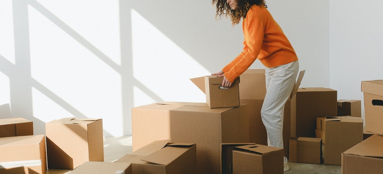 Girl sorting out boxes after doing research on Chicago climate