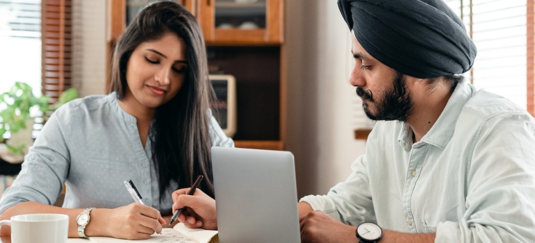 a couple calculating expenses together 