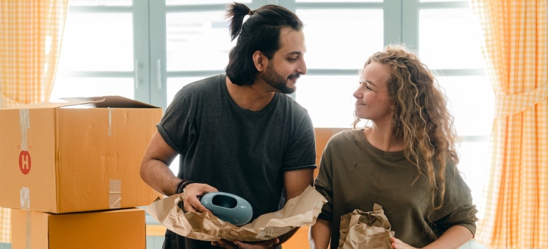 a happy couple packing before moving from San Antonio to Miami